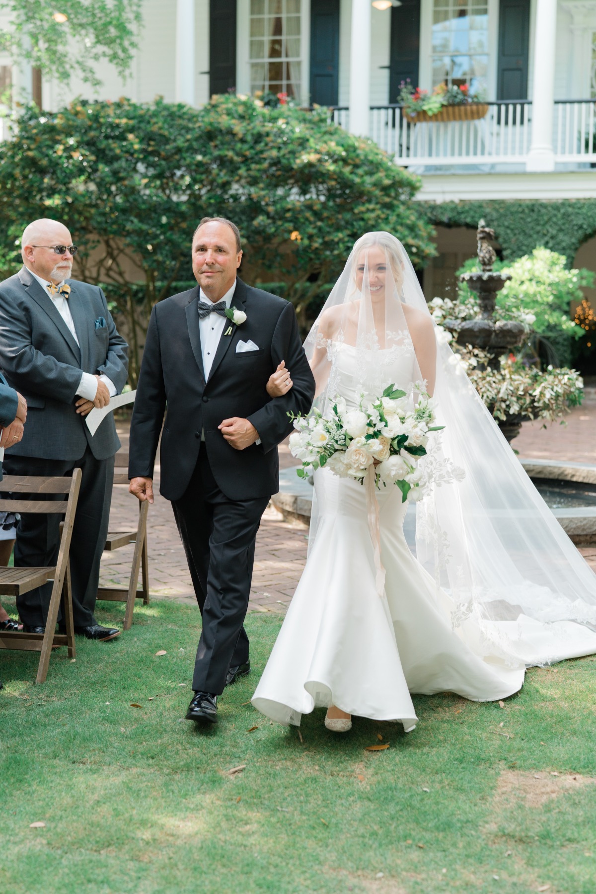 bride walking down the aisle with Father