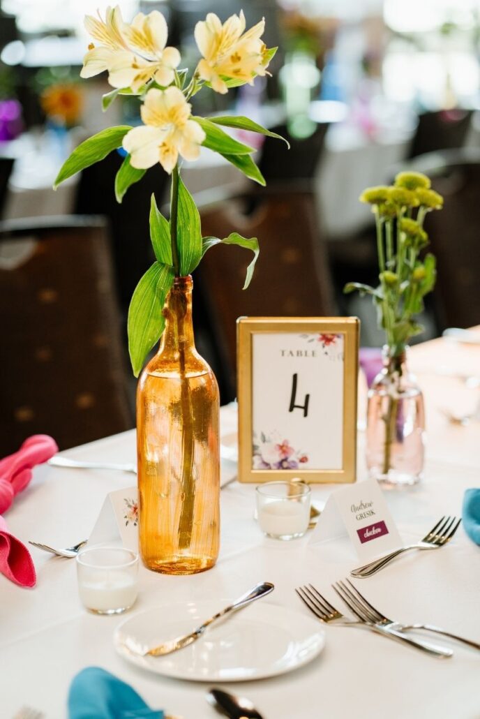 sweet vase and yellow flowers at reception