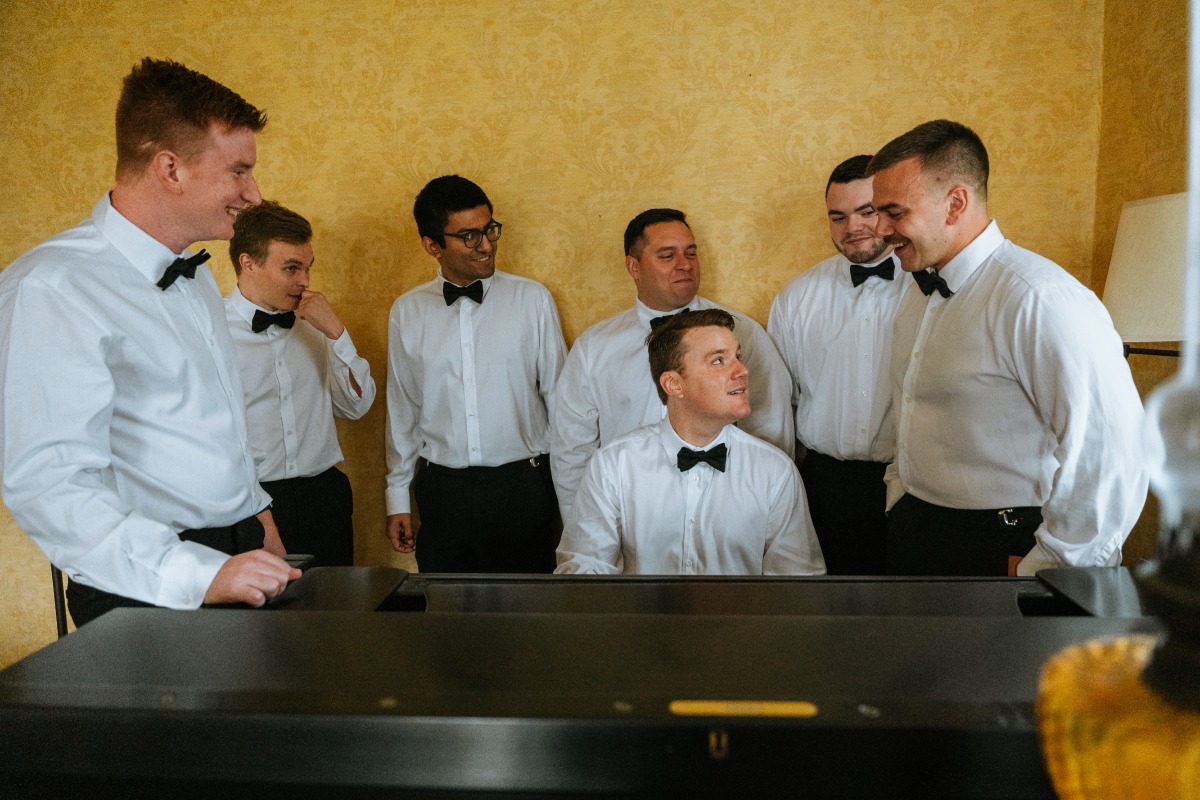 Vintage groomsmen playing piano