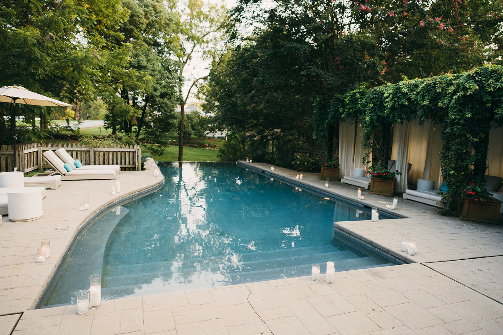 wedding reception with pool decorated with candles