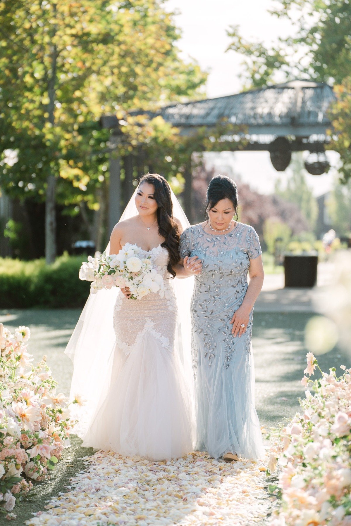 Mom walking glamorous bride down the aisle