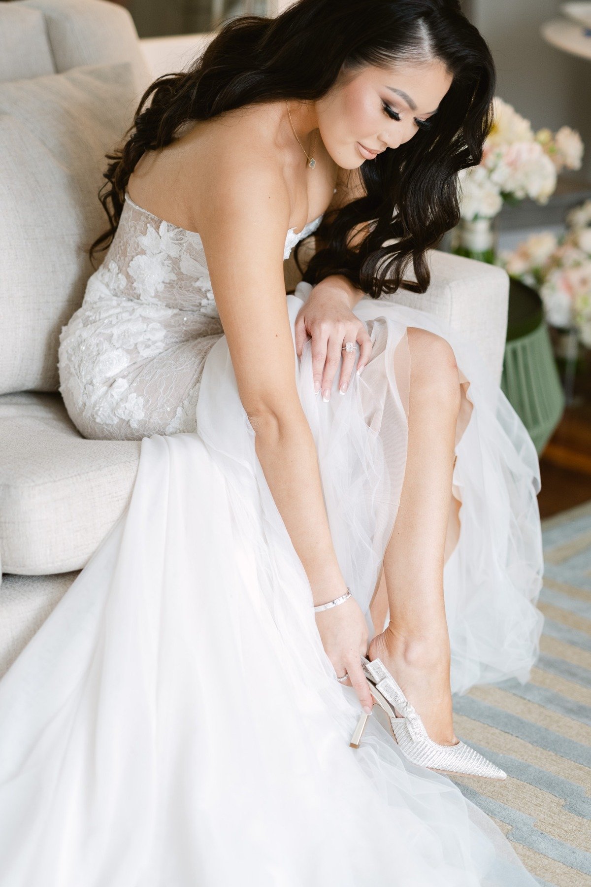 Luxury bride putting on Dior heels