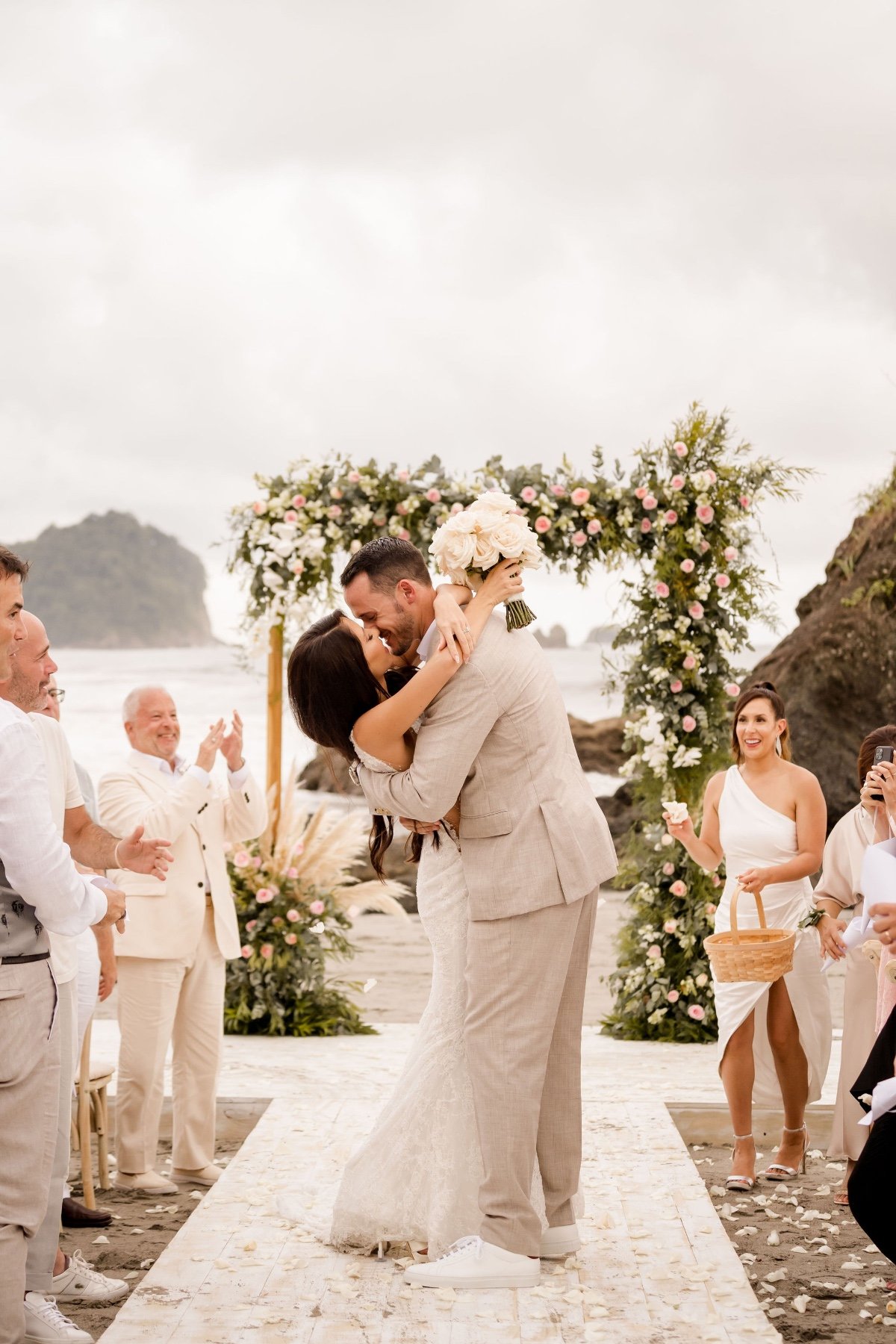 Costa Rican beach wedding ceremony with floral arch