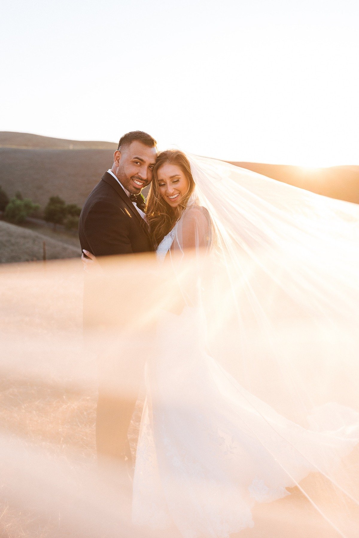 veil blowing in wind at mountaintop vineyard wedding