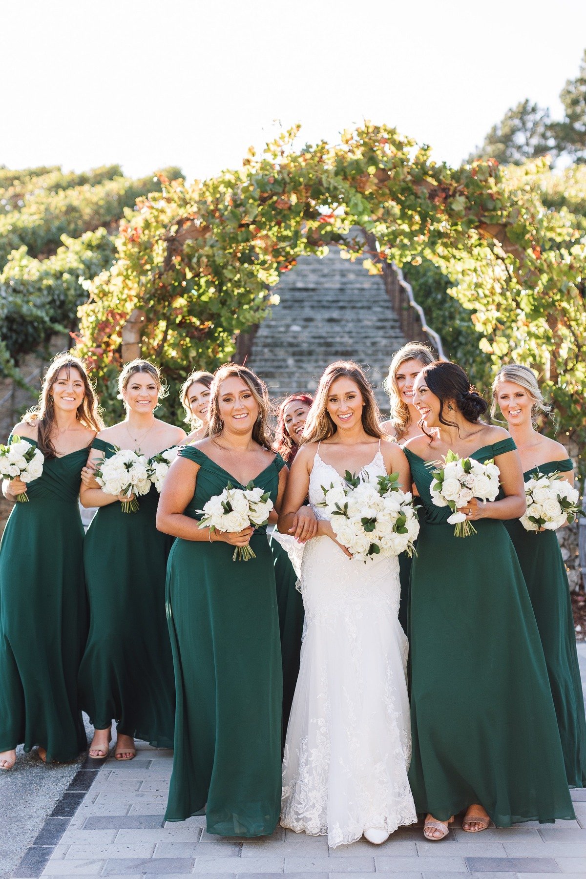 white lace mermaid wedding gown with off the shoulder green bridesmaid dresses