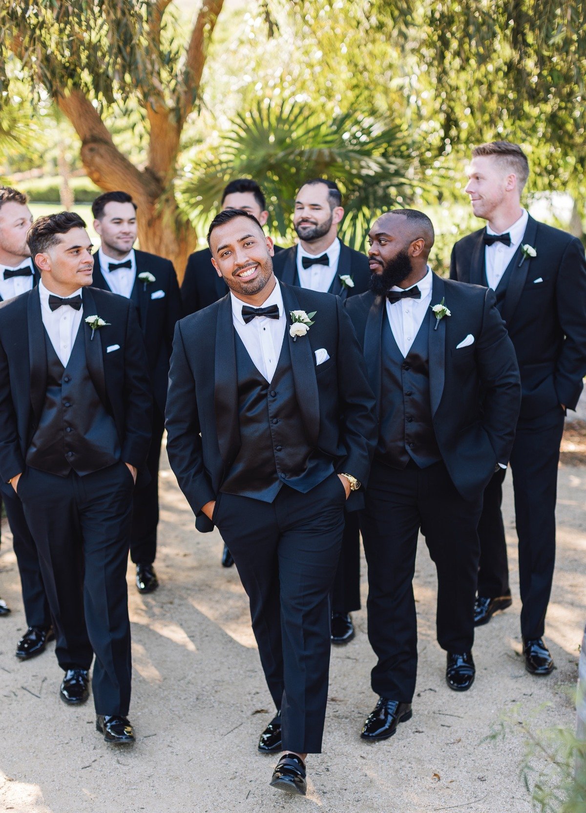 groom and groomsmen in three piece tux