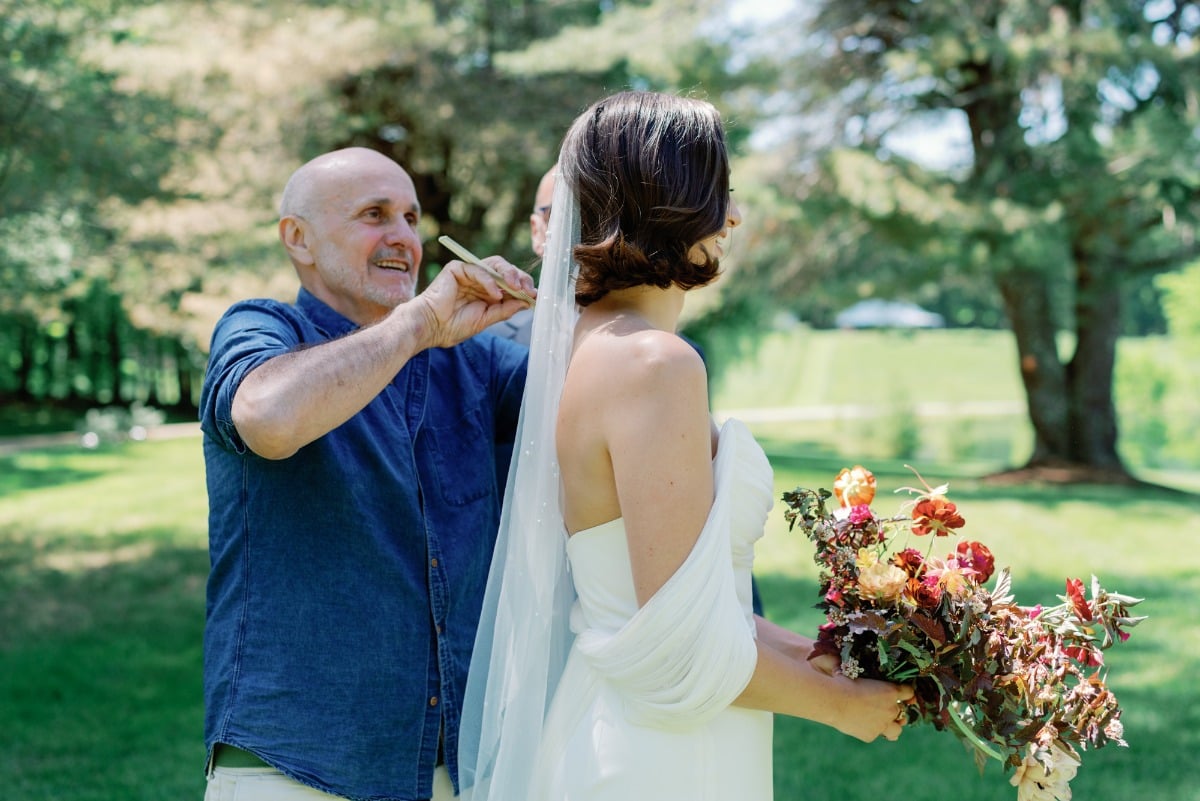 Final hair touch ups on the bride