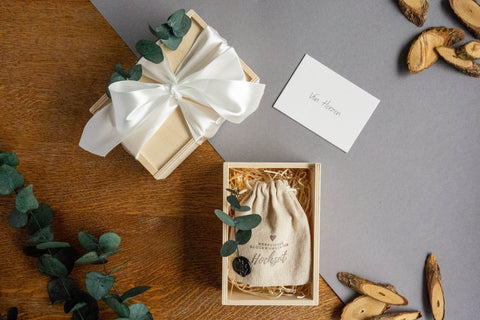 Wooden box with white bow, eucalyptus and greeting card, filled with burlap pouch