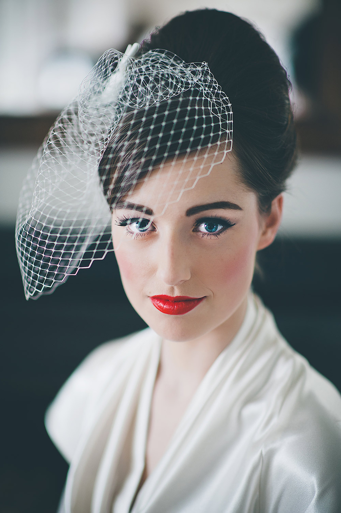 black hair with a veil updo wedding, red lipstick white dress