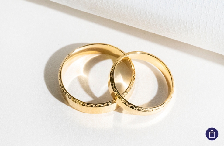 Golden wedding rings with a decorated edge