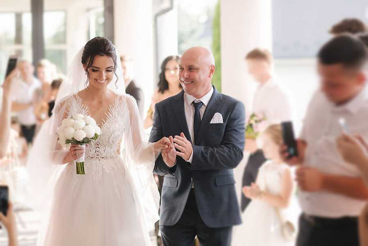 Father-daughter dance happy father leads his daughter to the Altar