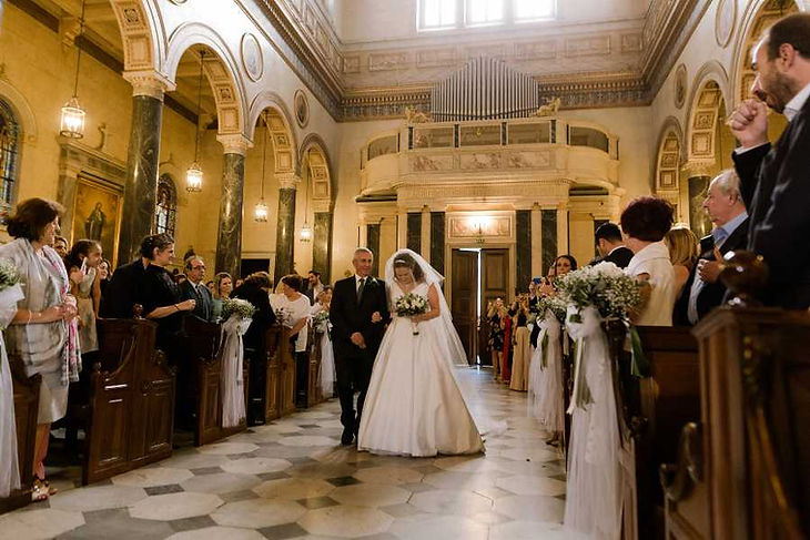 Father-daughter dance, father of the bride, walks with his daughter down the aisle 