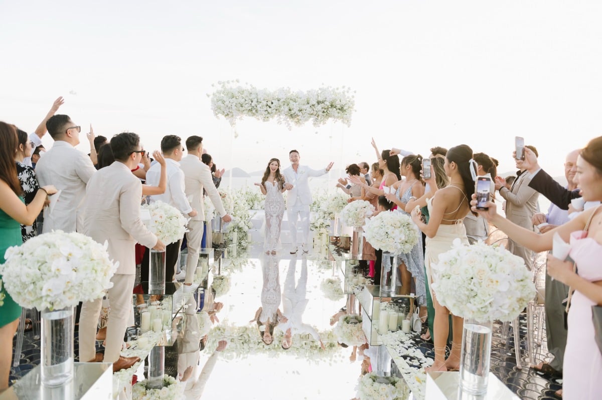 Newlyweds cheers after tropical Thai ceremony