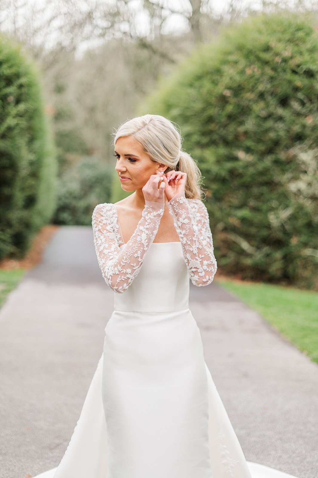 Southern bride adjusting earrings 