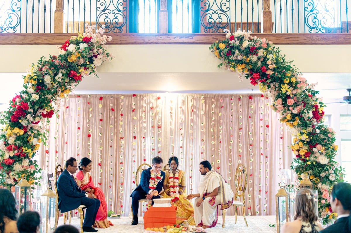 large colorful floral arch for wedding ceremony