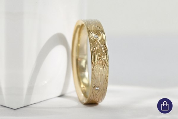 Wedding rings with an engraving such as a wood grain