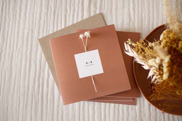 Rust red square wedding invitations with black and white flower