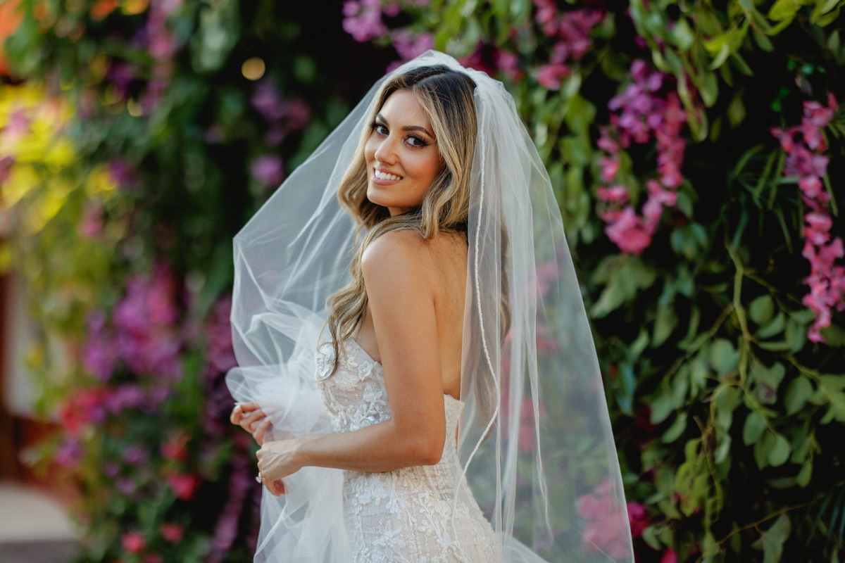 Gorgeous bride with pink floral wall 