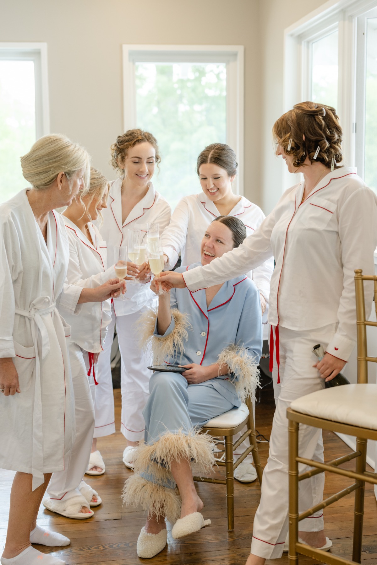 Bride in blue wedding pajamas with feathered sleeves 