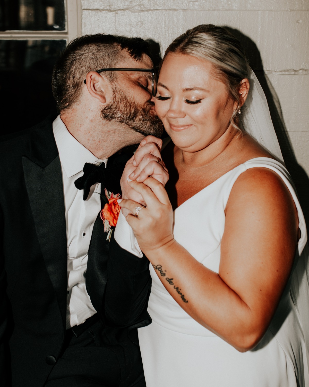 Groom kissing bride's cheek 