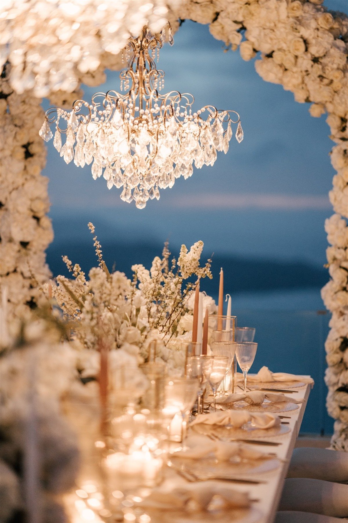 A white sunset micro-wedding with macro luxury details in Santorini