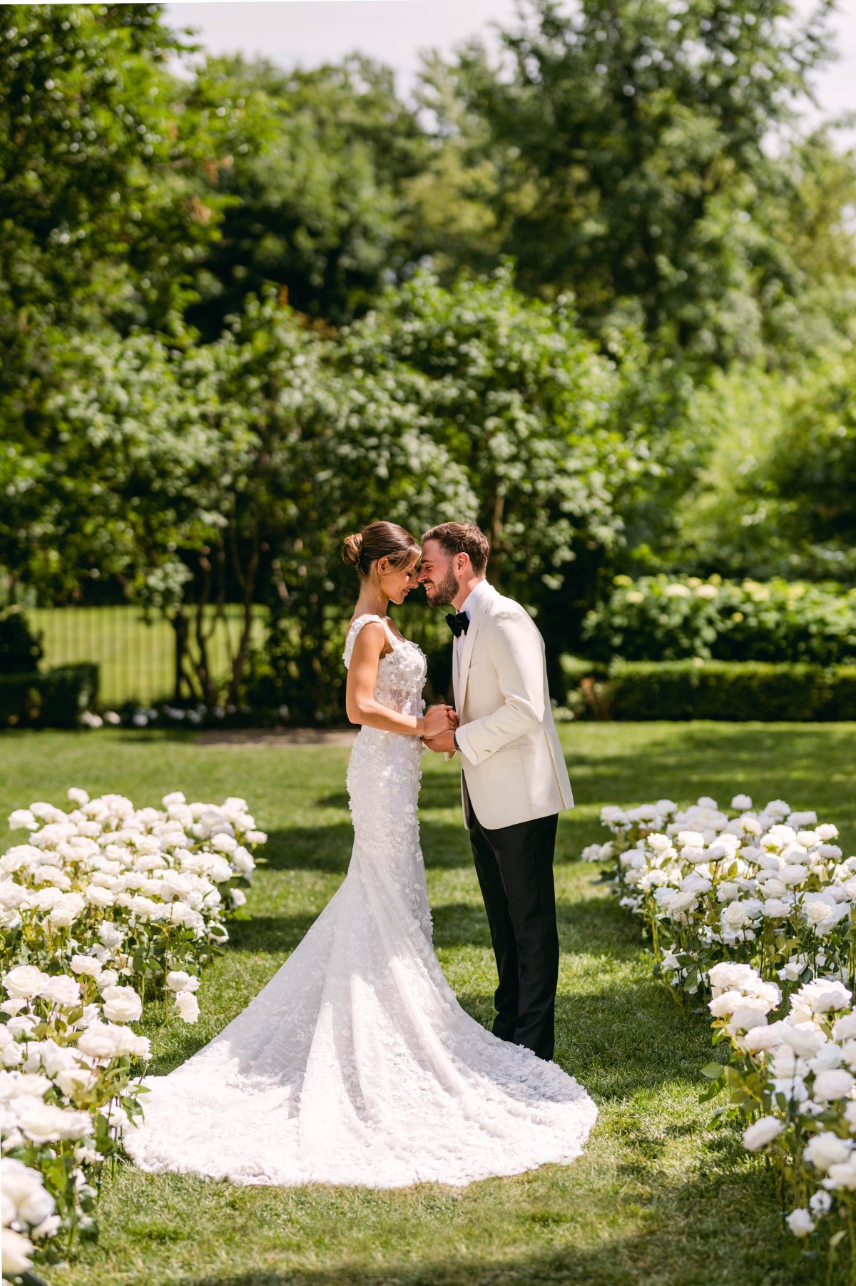 Bride and groom at floral runway style ceremony aisle 