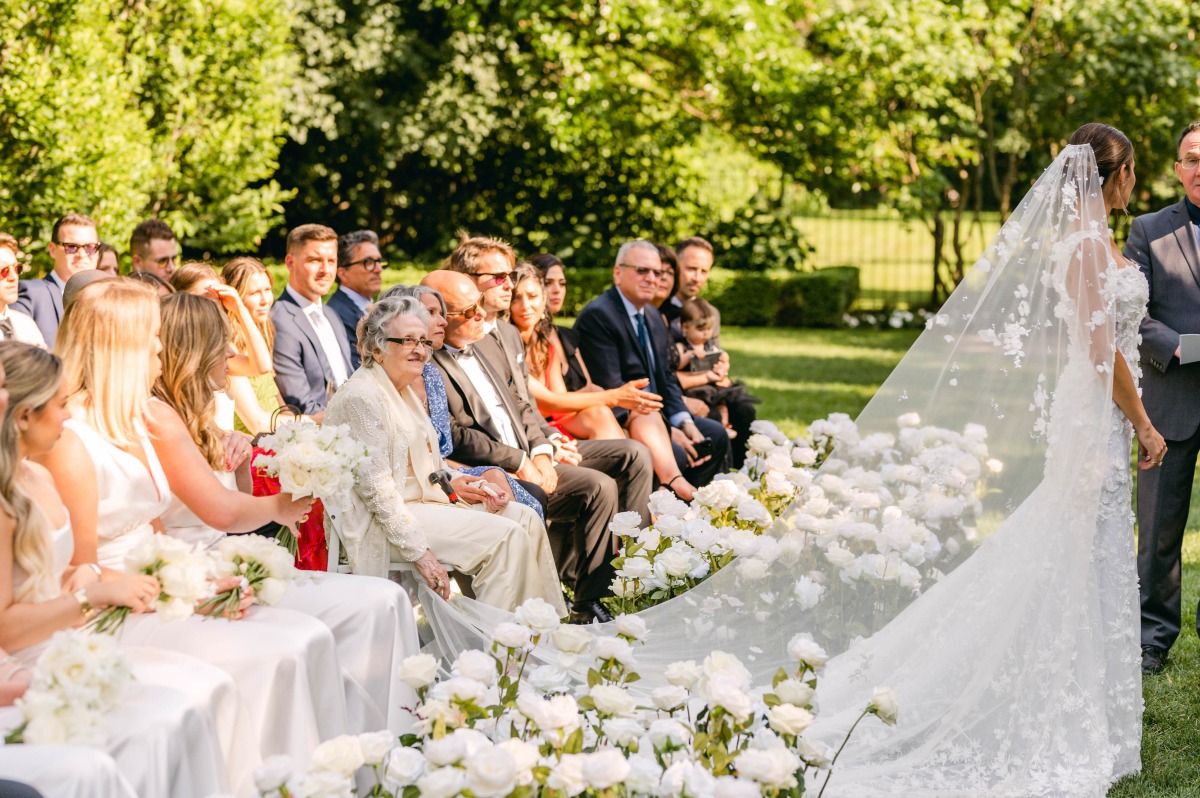 Bride walking down runway style aisle 