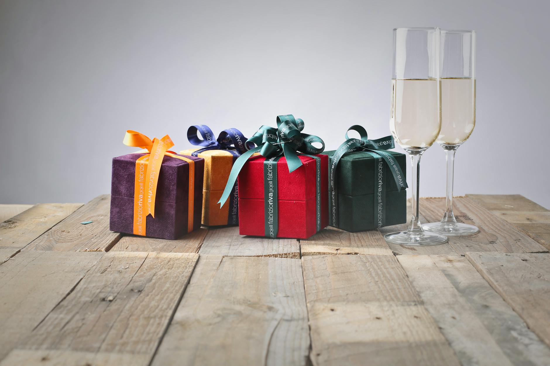 five assorted gift boxes and two flute glasses