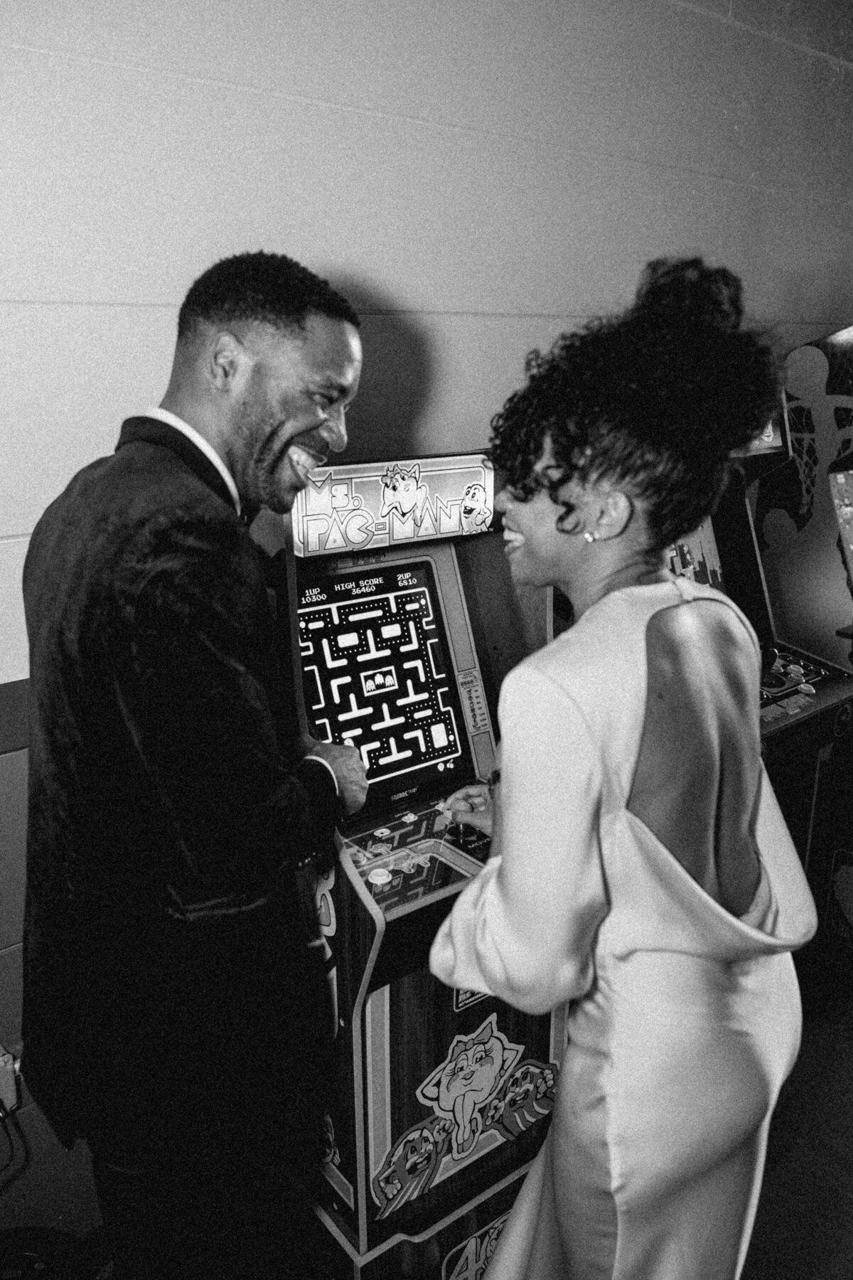 Bride and groom playing video games