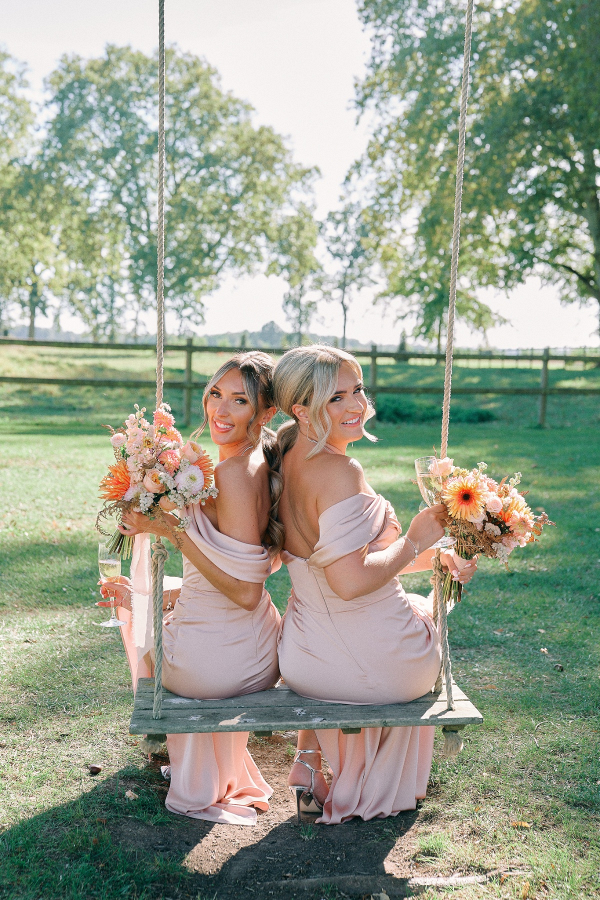 Pastel pink bridesmaids on swings 