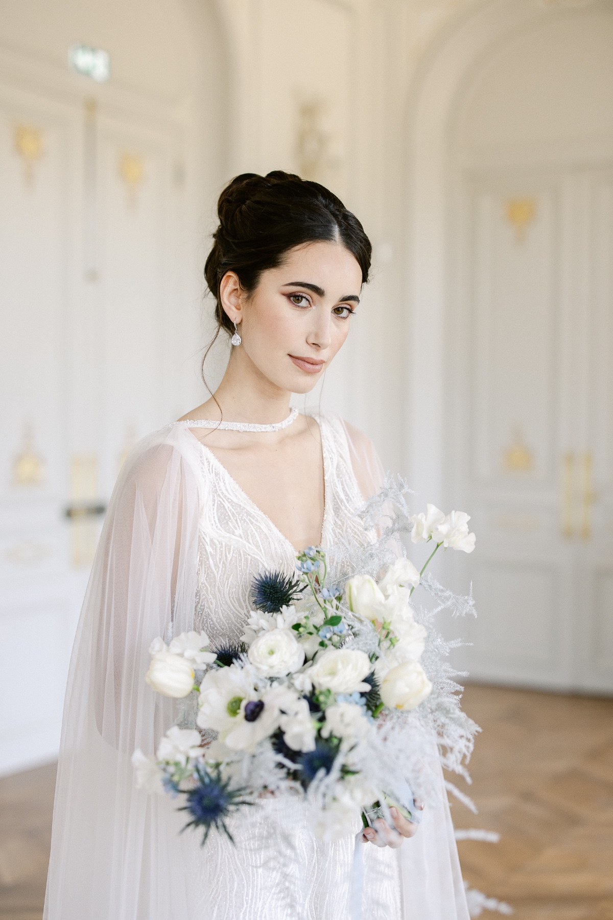 white wedding dress with blue and white wedding bouquet