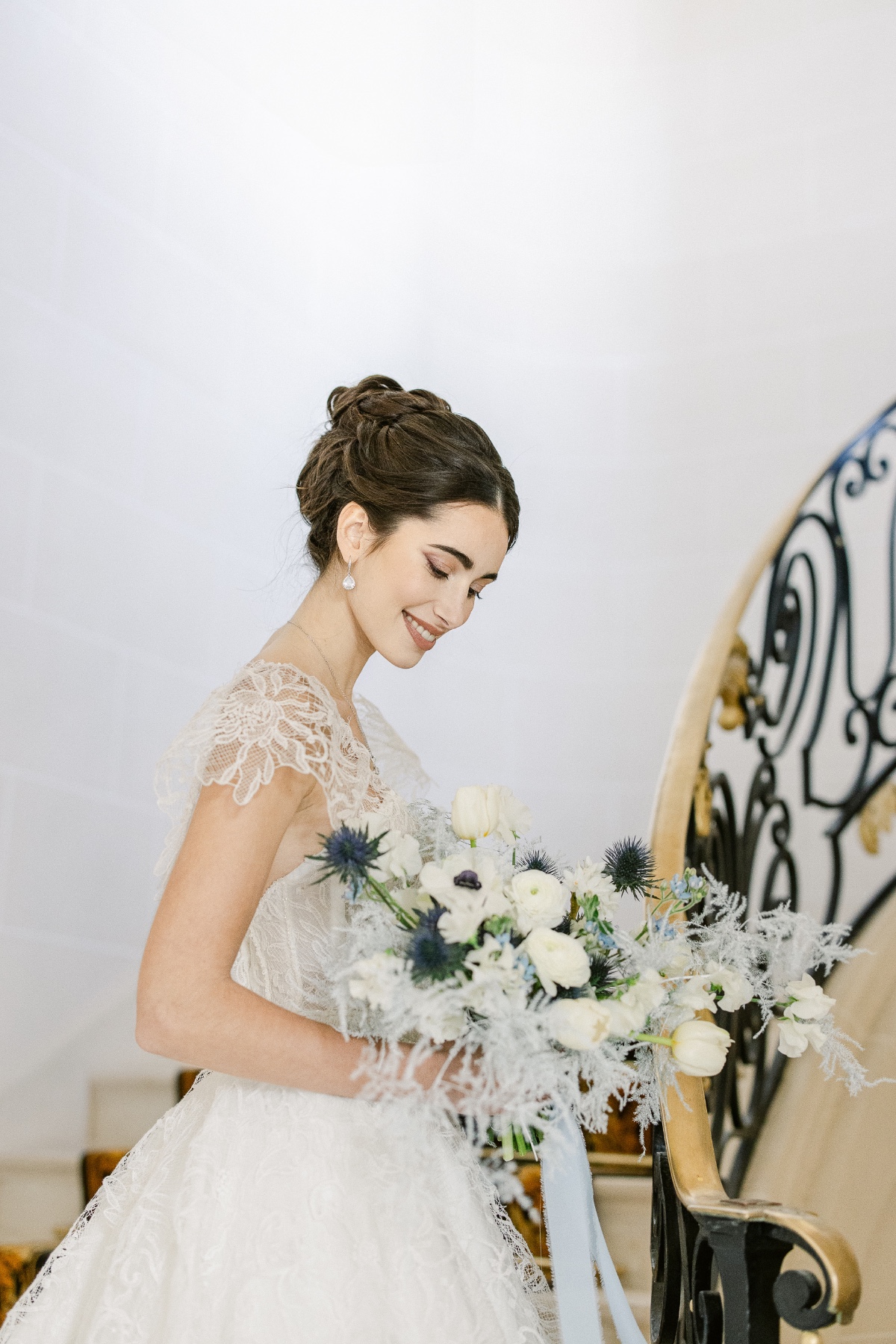 lace wedding dress paired with white and blue wedding bouquet