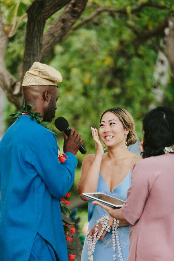 bride crying while she smiles at the Hawaii wedding ceremony