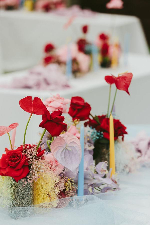 red anthuriums and mismatched taper candles