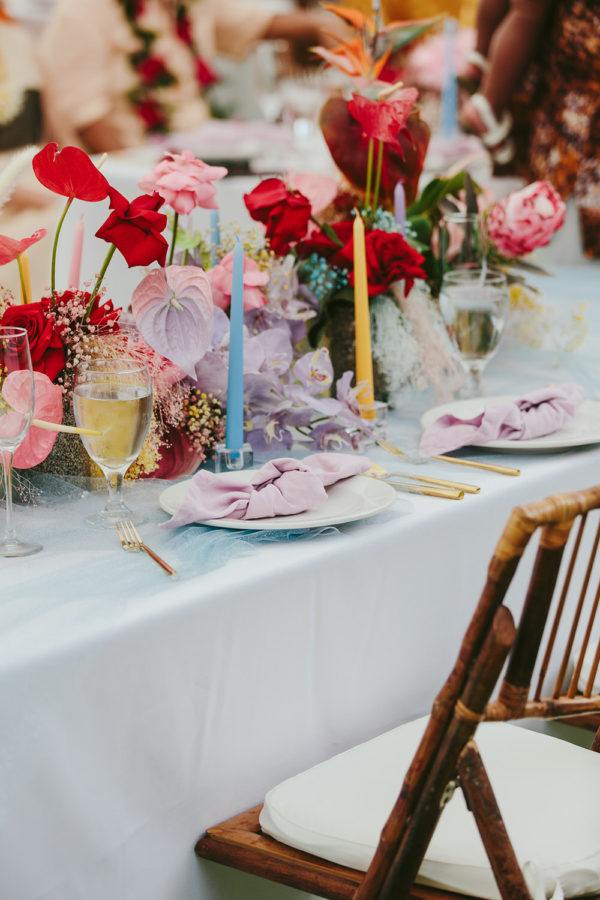 bamboo chairs with colorful florals and tall taper candles