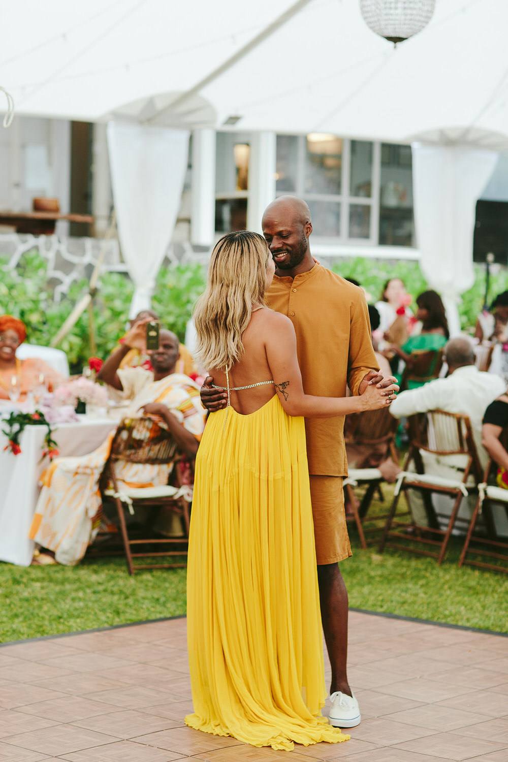 couple slow dances during their reception in Hawaii