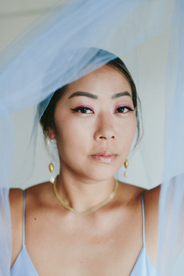 bride getting ready in her blue dress with blue veil