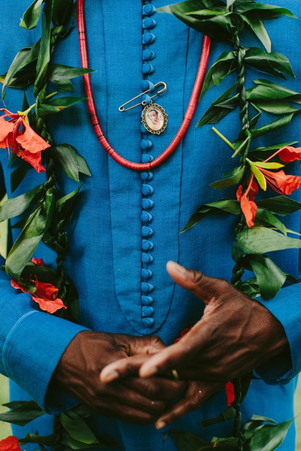 groom's blue ceremony outfit with custom lei