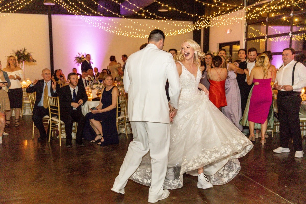 bride and groom dancing in sneakers at wedding