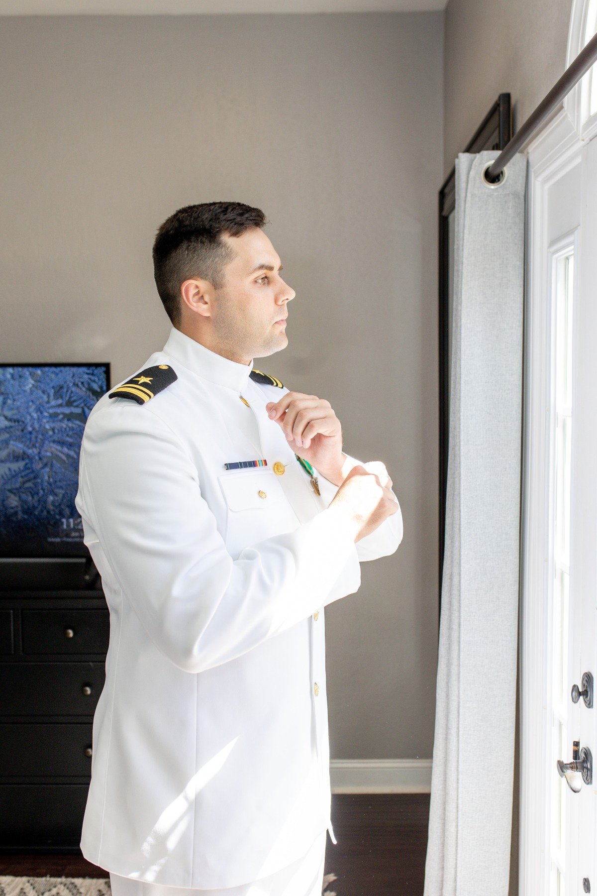 groom getting ready in navy seal uniform