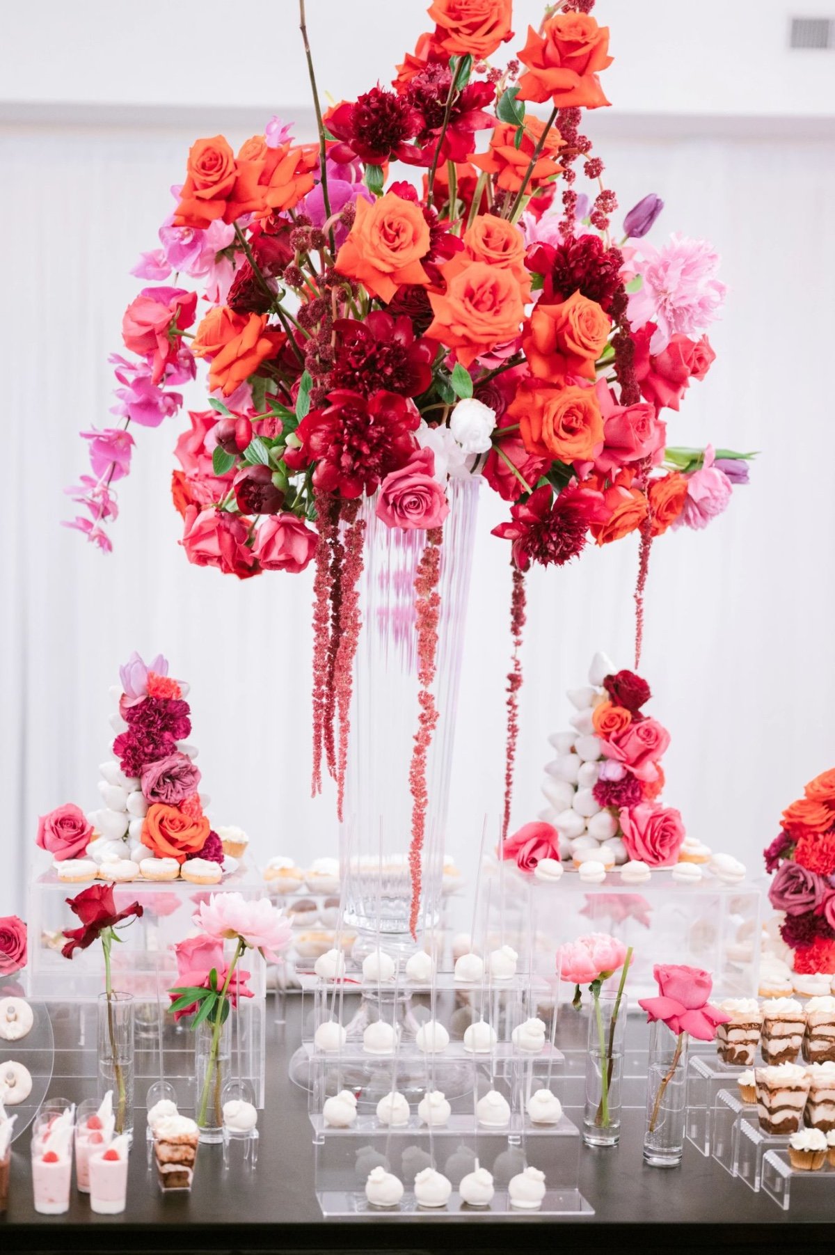 modern pink and red dessert table at wedding