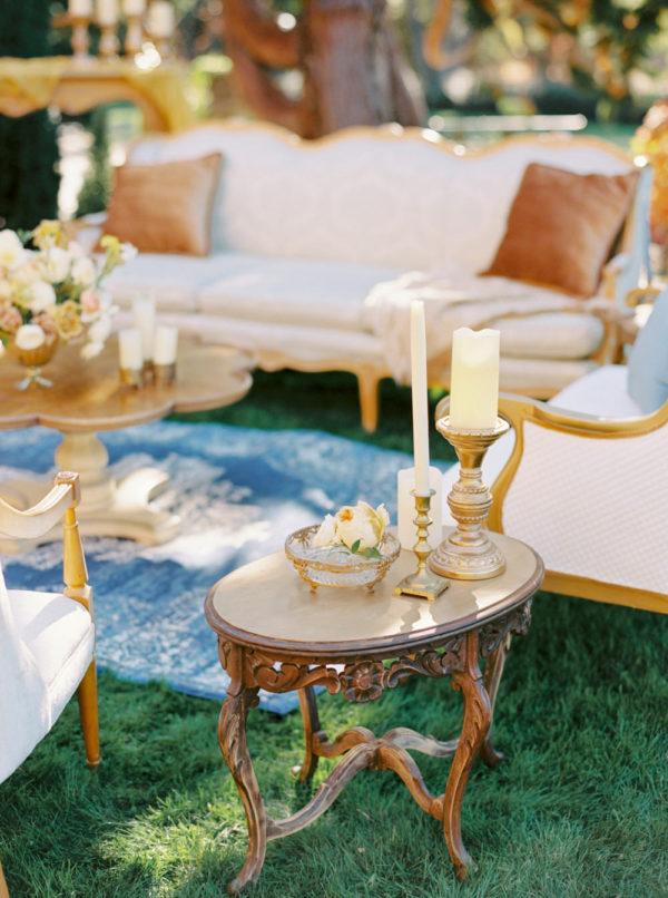 cocktail hour decor pieces with tall candles and velvet pillows