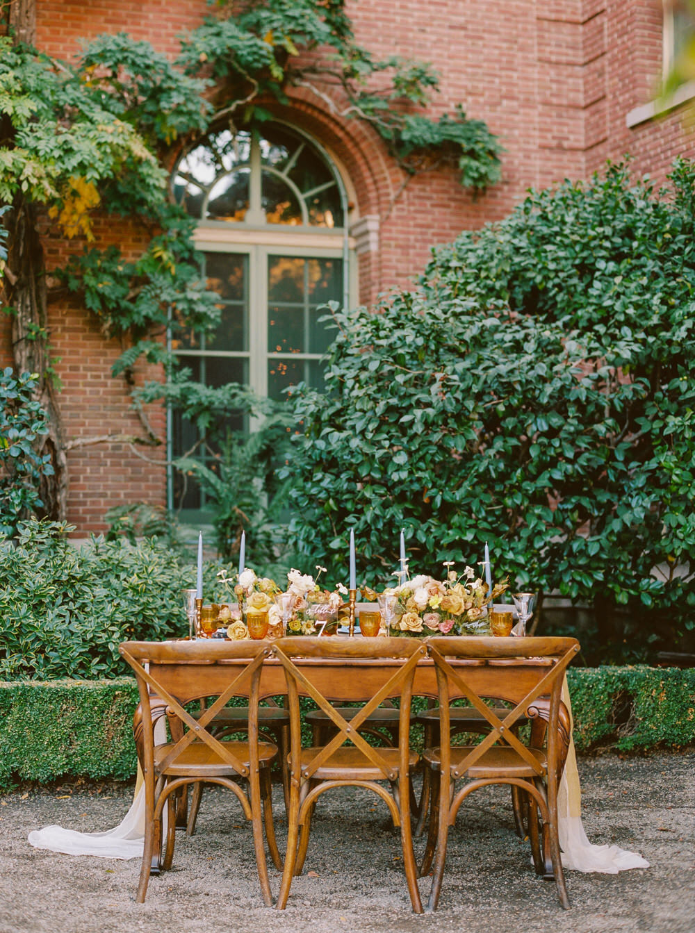 intimate wedding reception with wooden cross backed chairs