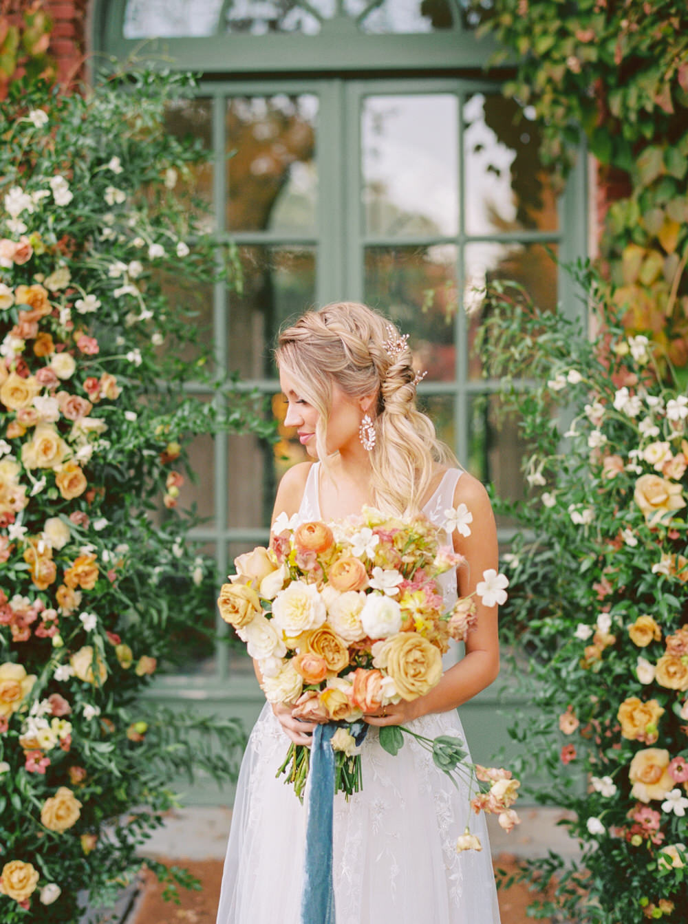 bridal portrait holding her lush pastel bouquet