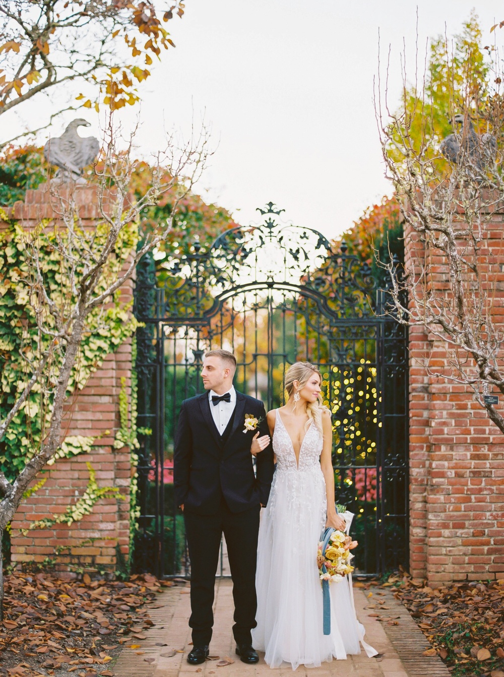 couple portrait in front of a large iron gate