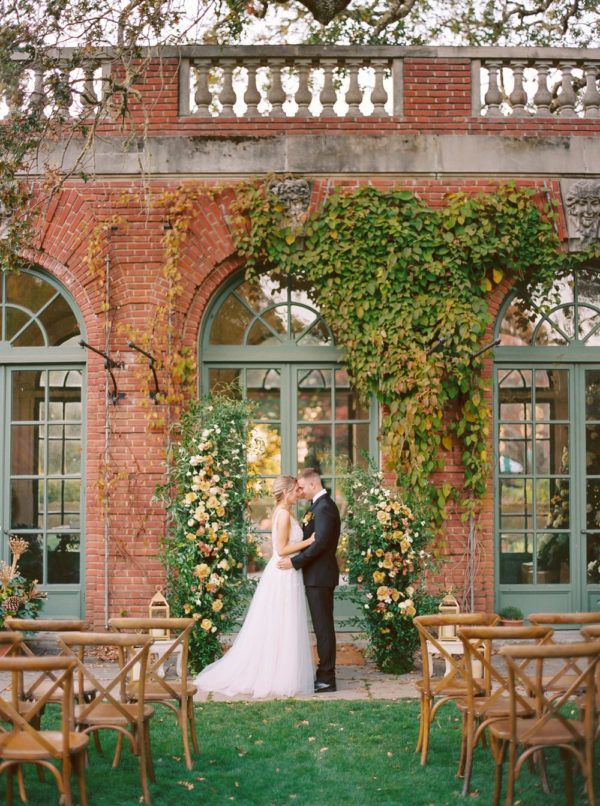 bride and groom touch foreheads while at their wedding ceremony