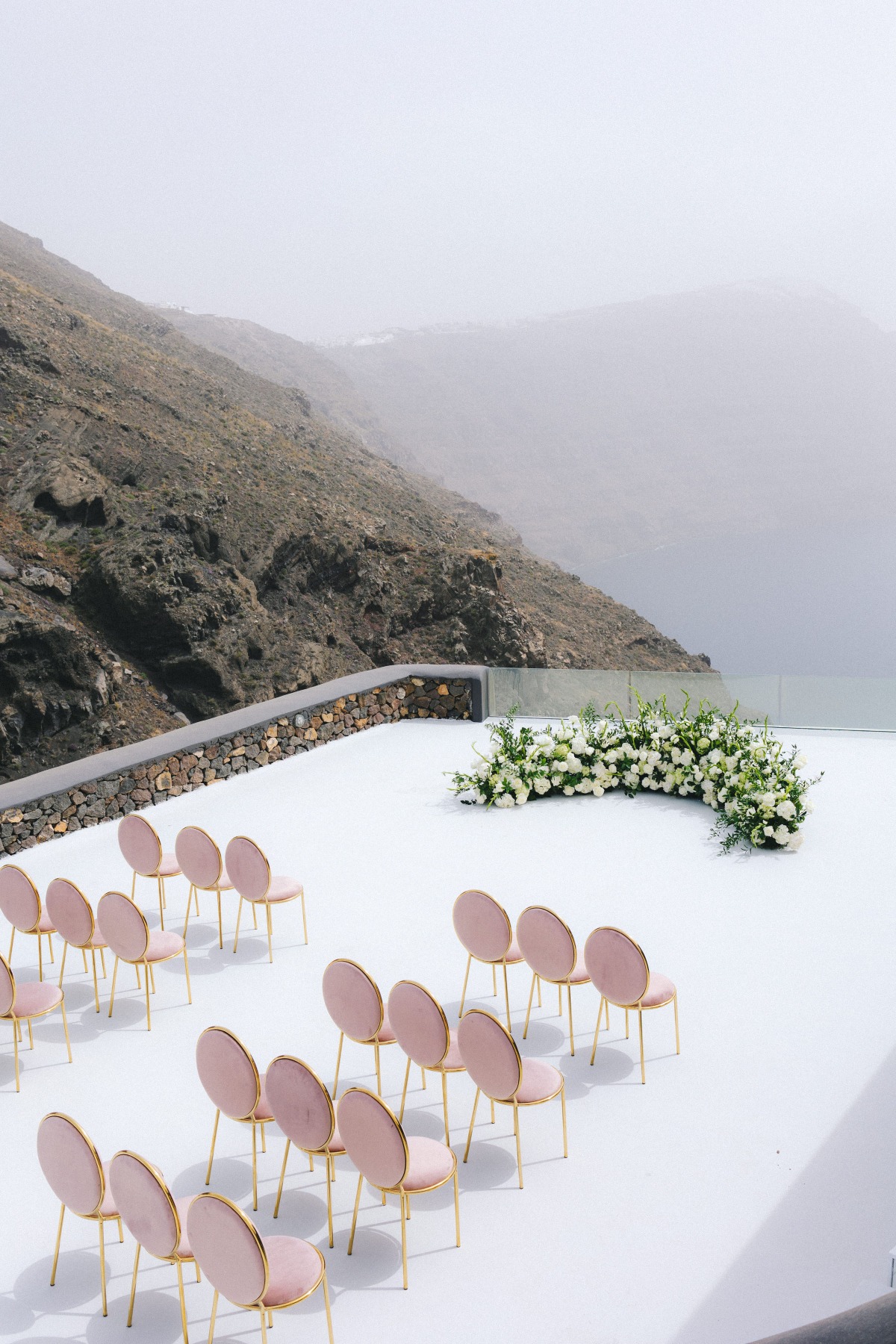 destination wedding ceremony on the cliffs of santorini