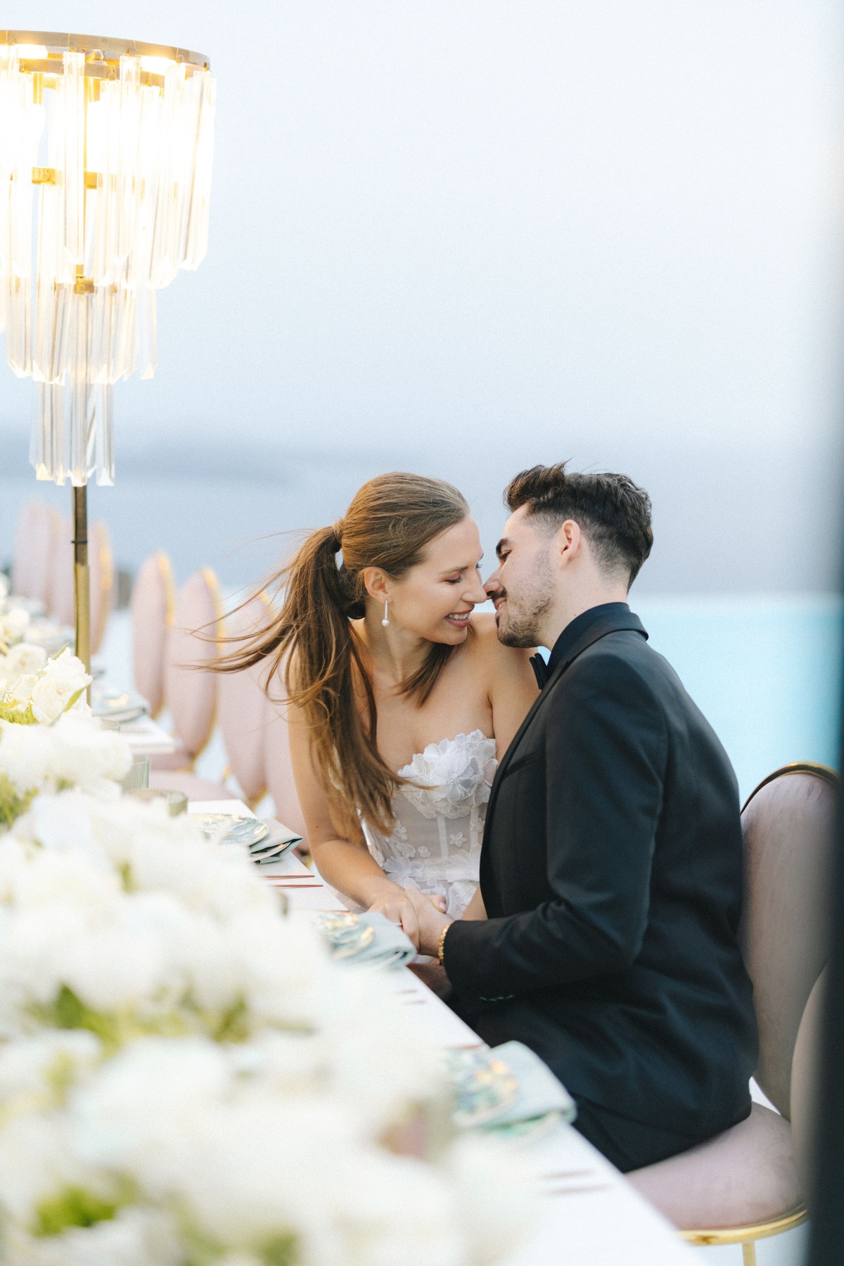 bride and groom at pink and gold seaside wedding reception