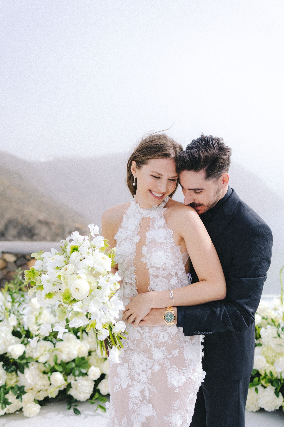 bride and groom at cliffside wedding in santorini