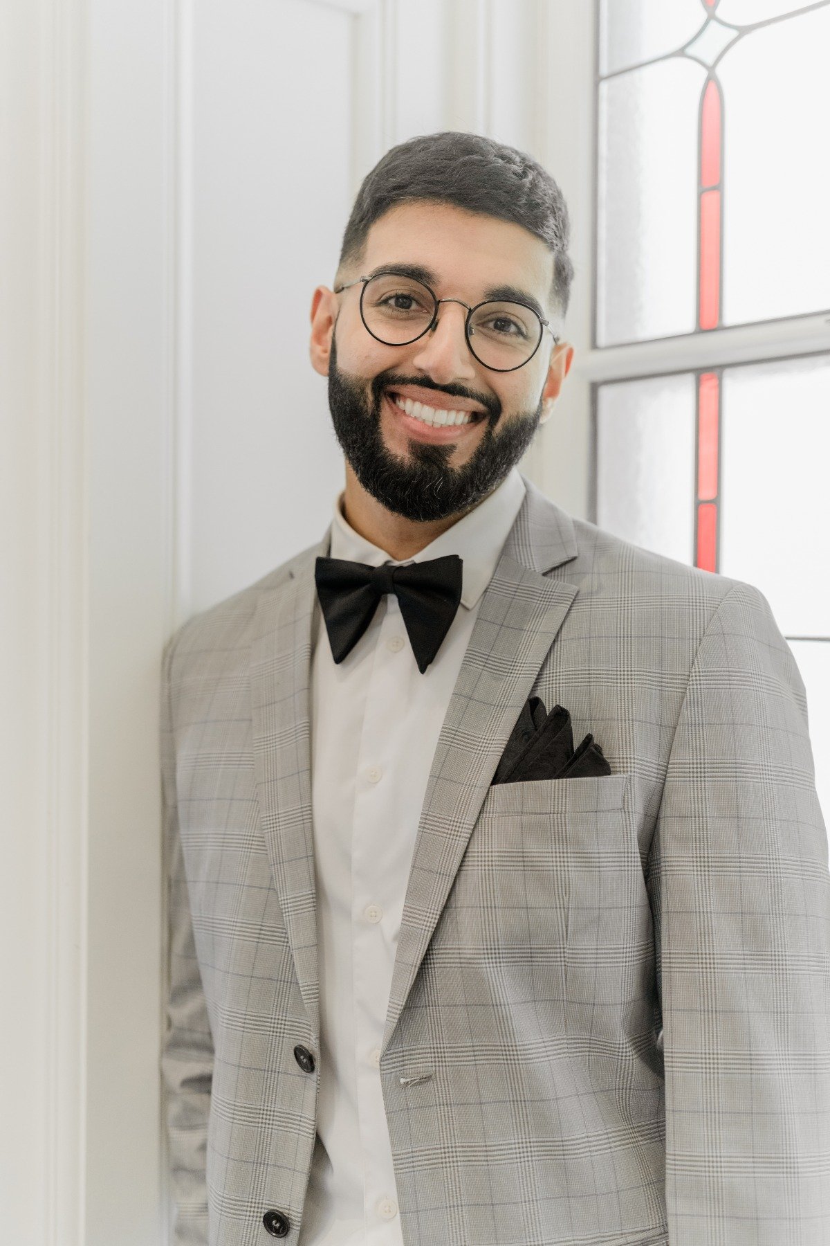 grey suit with classic black bow tie